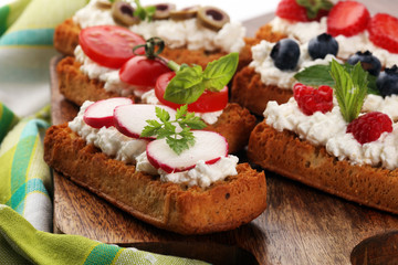 Obraz na płótnie Canvas Bread Brushetta or authentic traditional spanish tapas set for lunch table. Sharing antipasti on party or summer picnic time over wooden rustic background.