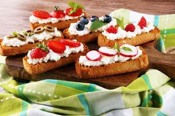 Bread Brushetta or authentic traditional spanish tapas set for lunch table. Sharing antipasti on party or summer picnic time over wooden rustic background.