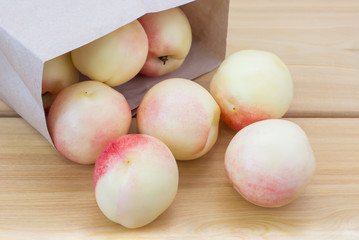 Fresh peaches, Peach close up fruit background, peach on wood background,sweet peaches in the paper bag