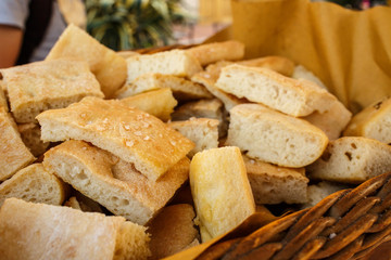 Pieces of tasty Italian bread lie in a bascket