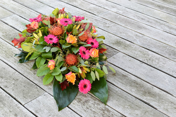 Flower arrangement on wooden background.