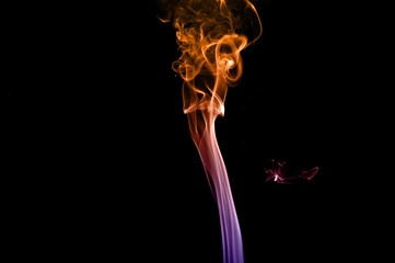 Obraz premium Abstract colorful smoke on black background, colorful ink background,Violet,purple, Orange, beautiful smoke