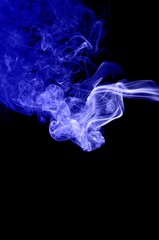 Fototapeta premium Abstract blue smoke on black background,blue ink background