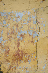 Abstract background of cracked yellow paint 
