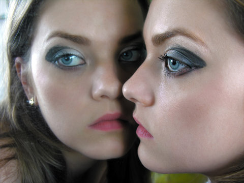  closeup portrait of attractive woman near the mirror 