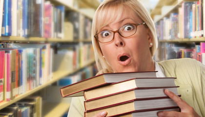 Beautiful Expressive Student or Teacher with Books in Library.