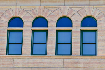 Four antique windows in a limestone building
