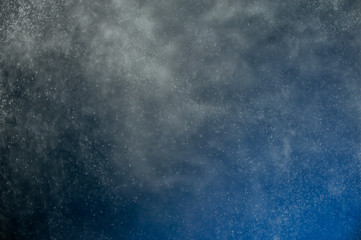 abstract water spray on blue background 