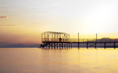 Fototapeta na wymiar Colorful Sunset and a pier with long exposure