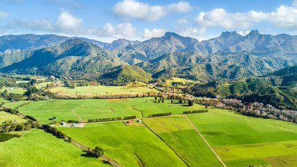 Aerial view on a farmland at the foot of mountain ridge. Coromandel, New Zealand