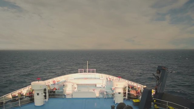 Ferry boat travelling in the middle of the ocean against a dramatic sky. Destination Paros island in Greece. View from the front of the ship.