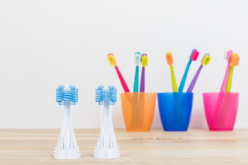 Ultra fine toothbrushes in colorful glasses and electric modern tooth brush closeup. Dental...