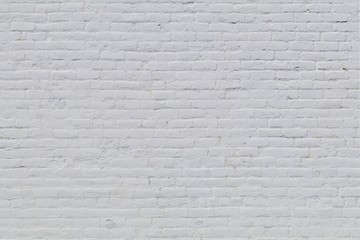 Solid old brick wall with white paint