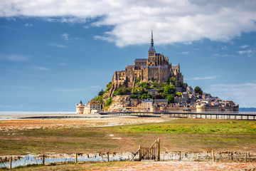 Fototapeta na wymiar Beautiful panoramic view of famous Le Mont Saint-Michel tidal island with blue sky. Normandy, northern France