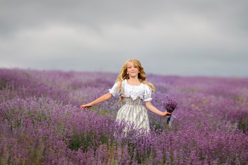 Walking girl in the field of lavender