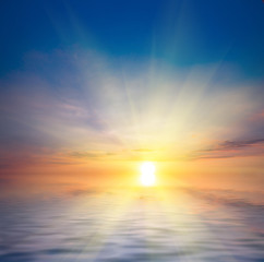 Naklejka na ściany i meble Beautiful sunset at the sea and sun with rays.