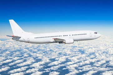 Fototapeta na wymiar Passenger white airplane on the side view, flies on a flight level sky