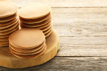 Tasty pancakes on grey wooden table