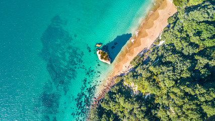 Aerial view on a small beach surrounded by rocks and forest. Coromandel, New Zealand © Dmitri