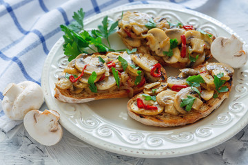 Ciabatta with mushrooms and onions on a white plate.