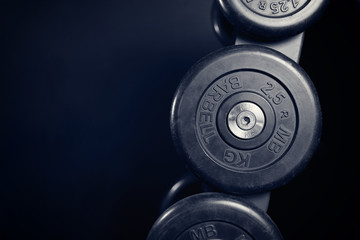 Naklejka na ściany i meble Dumbbells. A series of iron dumbbells in the gym. Copy space