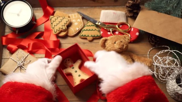 Video of Santa Claus hands preparing gifts for Christmas 