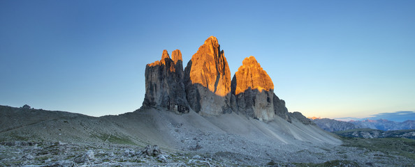 panorama with three rocks in orange light in Italy