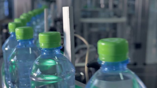 An endless factory line with capped PET bottles. 