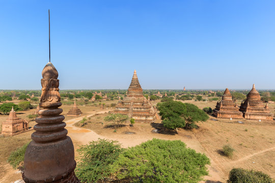 Many old pagodas and other buildings at the ancient plain of Bagan in Myanmar (Burma), viewed from the Bulethi (Buledi) Temple on a sunny day.
