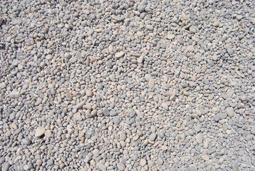 Pebbles on the beach. Rocky beach. Background of small stones. Pattern of small stone