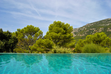 View from the pool to the mountains and green trees.