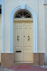 Traditional wooden painted yellow door in Malta