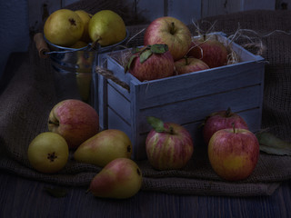 Juicy fruits in old white vintage wooden box. Red apples and yellow pears. Low key moon light 02