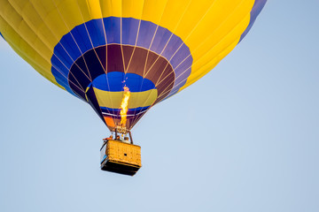 Colorful of Hot air balloon with fire and blue sky background