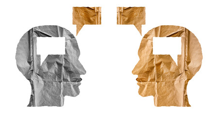 Crumpled paper shaped as a human heads and talk balloons on white background.
