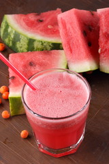 Watermelon cocktail and slices of watermelon on an old rusty background