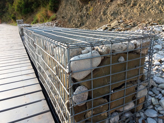 Stones in metal wire cage - Steel mesh of gabion wall