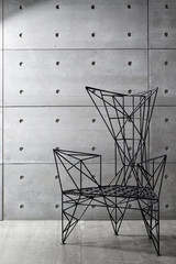 modern metal chair and concrete wall. copy space