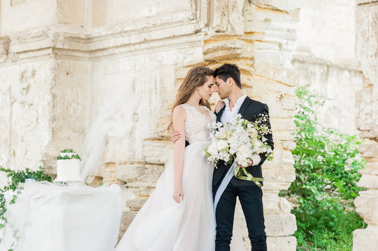 Bride and groom at wedding ceremony by the old cathedral