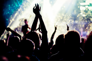 Obraz na płótnie Canvas crowd with raised hands at concert - summer music festival