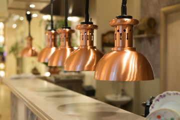 A group of hanging lights above the bar in restaurant