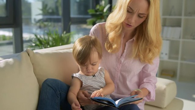 Careful mother reading stories to the child