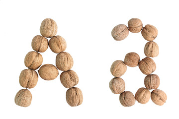 The group of walnuts on white background, making letter A. Studio shot