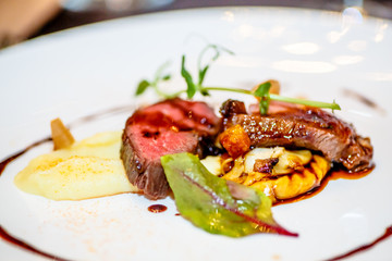 Slices of rare roasted beef with vegetables