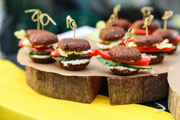 Healthy vegan raw burger. Healthy fast food on a cutting wooden board.