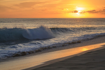 Shore break wave in Hawaii during the Sunset