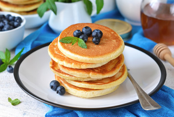 Homemade vanilla punkcakes with syrup and blueberries for breakfast. Good morning!