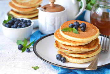 Homemade vanilla punkcakes with syrup and blueberries for breakfast. Good morning!