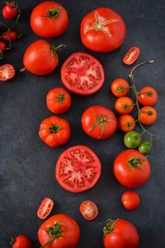 Fresh, juicy tomatoes on a black concrete background