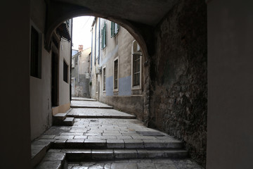 Fototapeta premium Sibenik / Tourist city by the Adratic sea - Sibenik, Croatia. The old stones, narrow street and stairs.